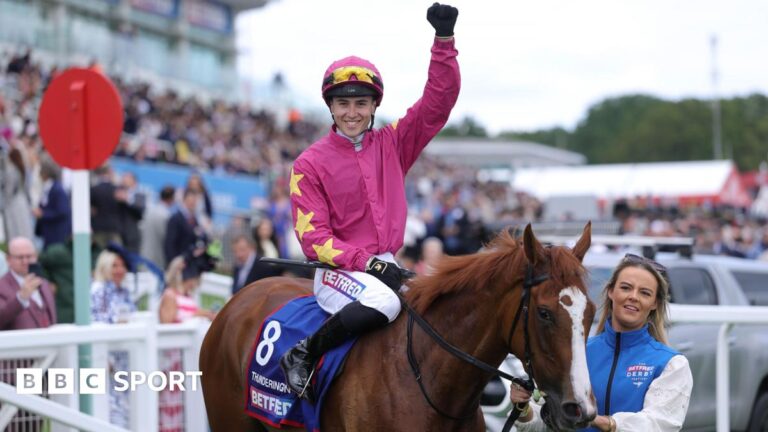 Dylan Browne McMonagle raises his fist in their in triumph aboard Thundering On at Epsom